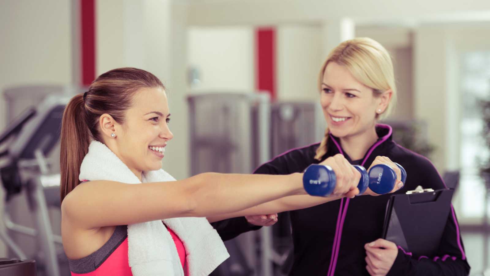 Woman exercising talking to Gym Attendant