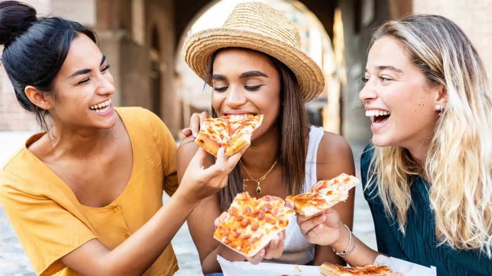 Woman eating pizza with friends
