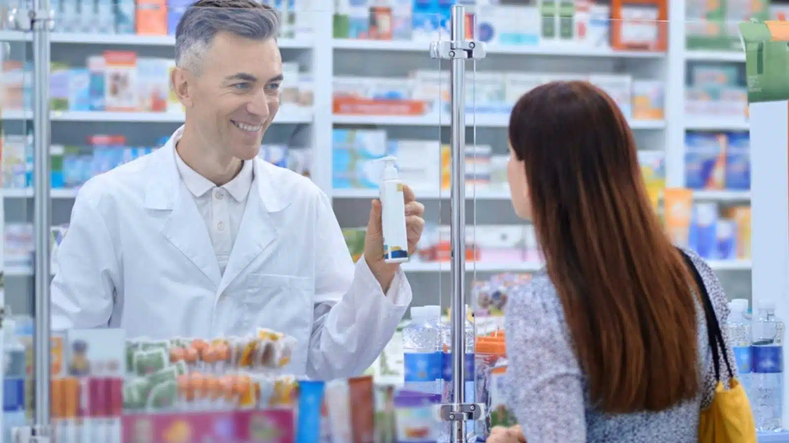 Woman buying medicine from pharmacy