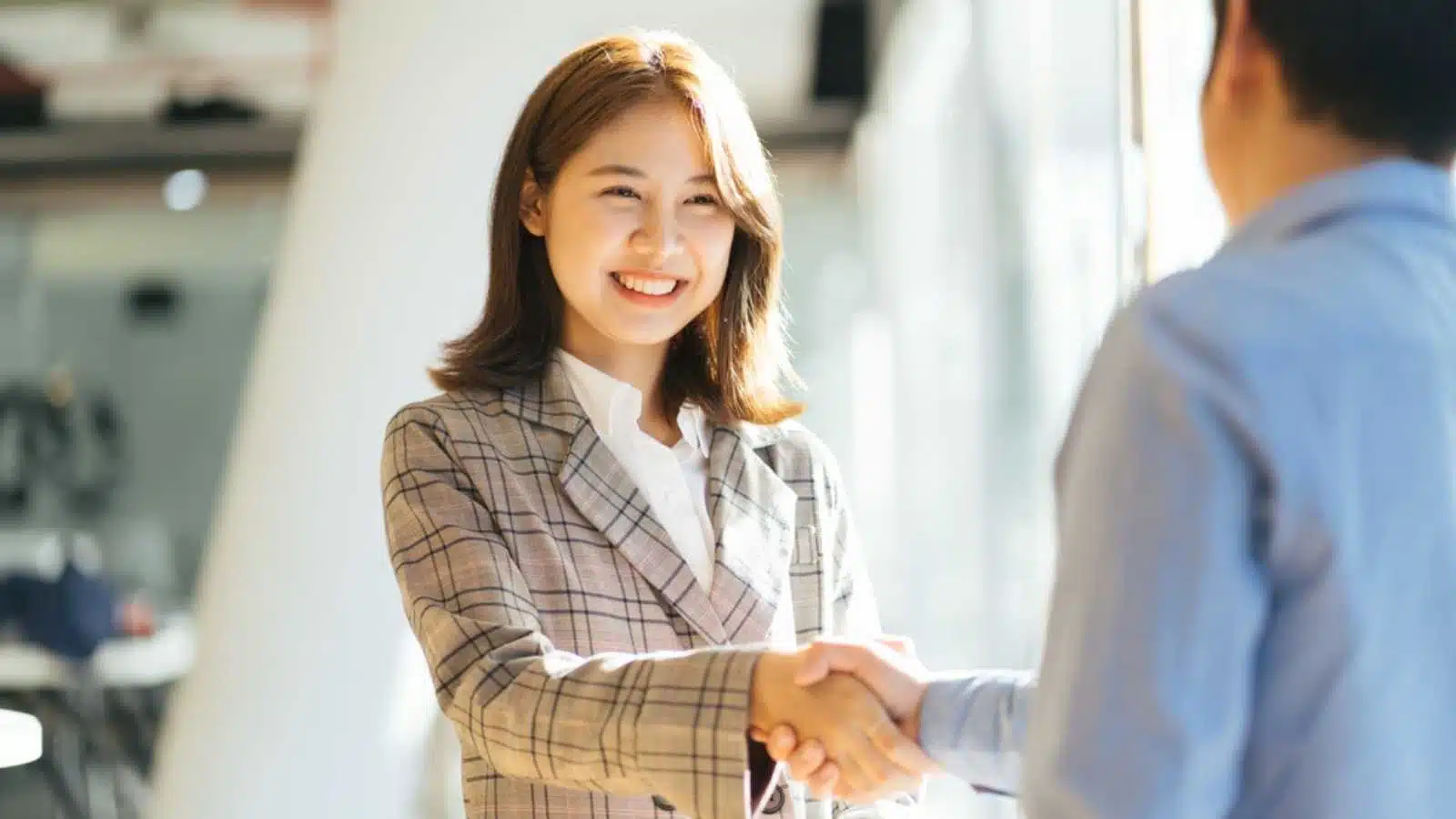 Woman shaking hands of staff