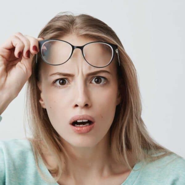 Woman shocked and removing specs