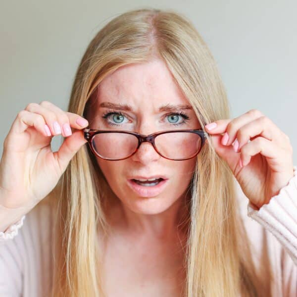 Shocked,Angry,Young,Woman,In,Disbelief,Lowering,Glasses,Looking,At