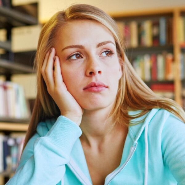 college girl library sad thinking