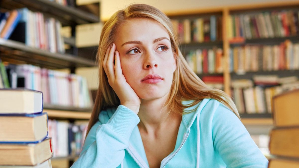 college girl library sad thinking