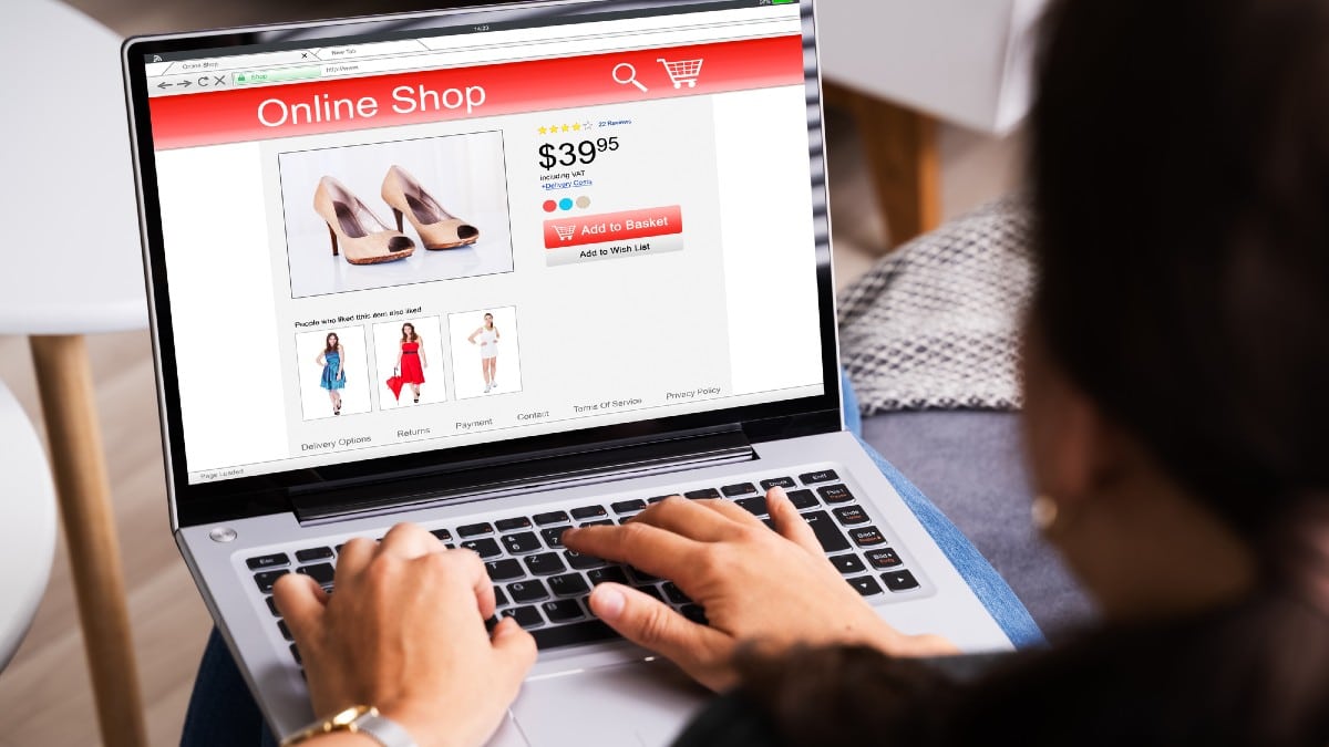 Happy Woman Shopping Online On Laptop Viewing Shoes
