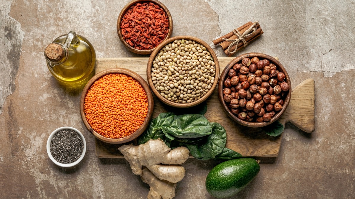 15 Smart Purchases That Keep Women in Control Top view of legumes, ginger, chia seeds and avocado on wooden board with rustic background — PhotoDOWNLOAD USING