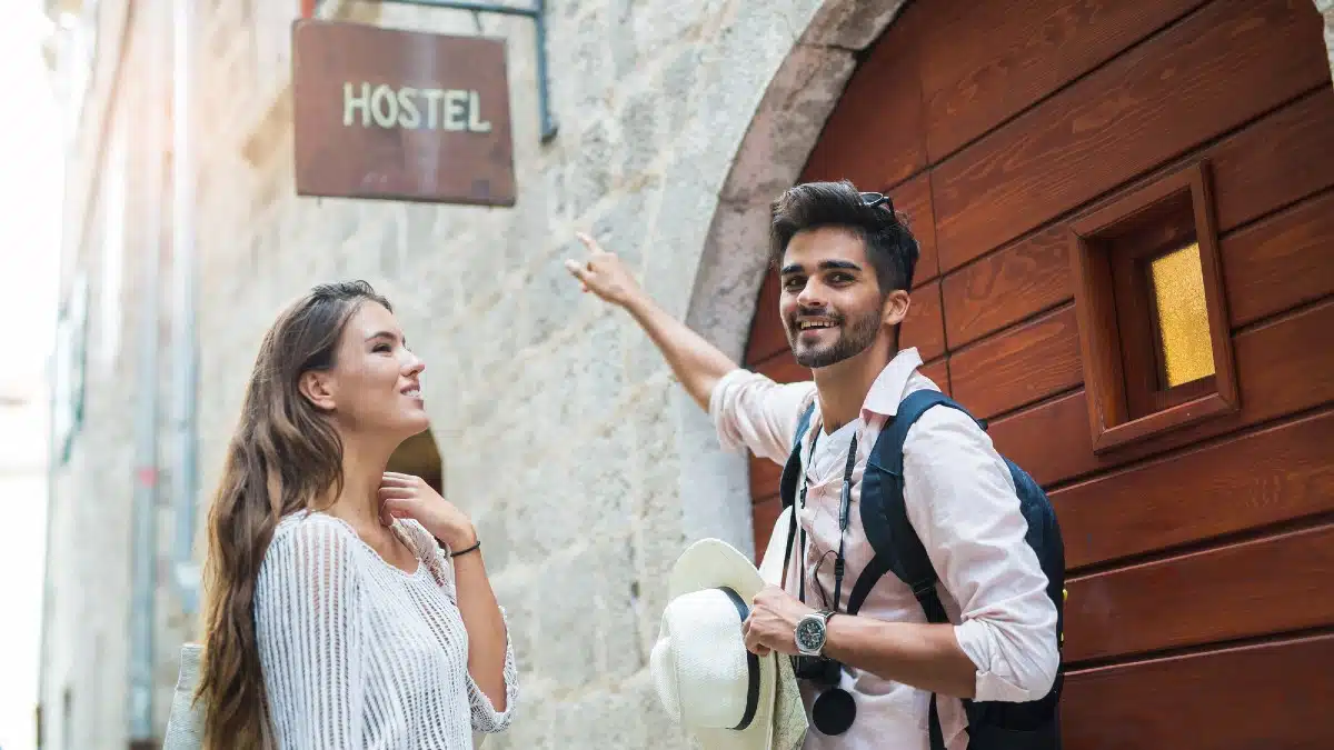 15 Ways to Enjoy Your Money Without Going Broke Tourist couple enjoying sightseeing and exploring city pointing