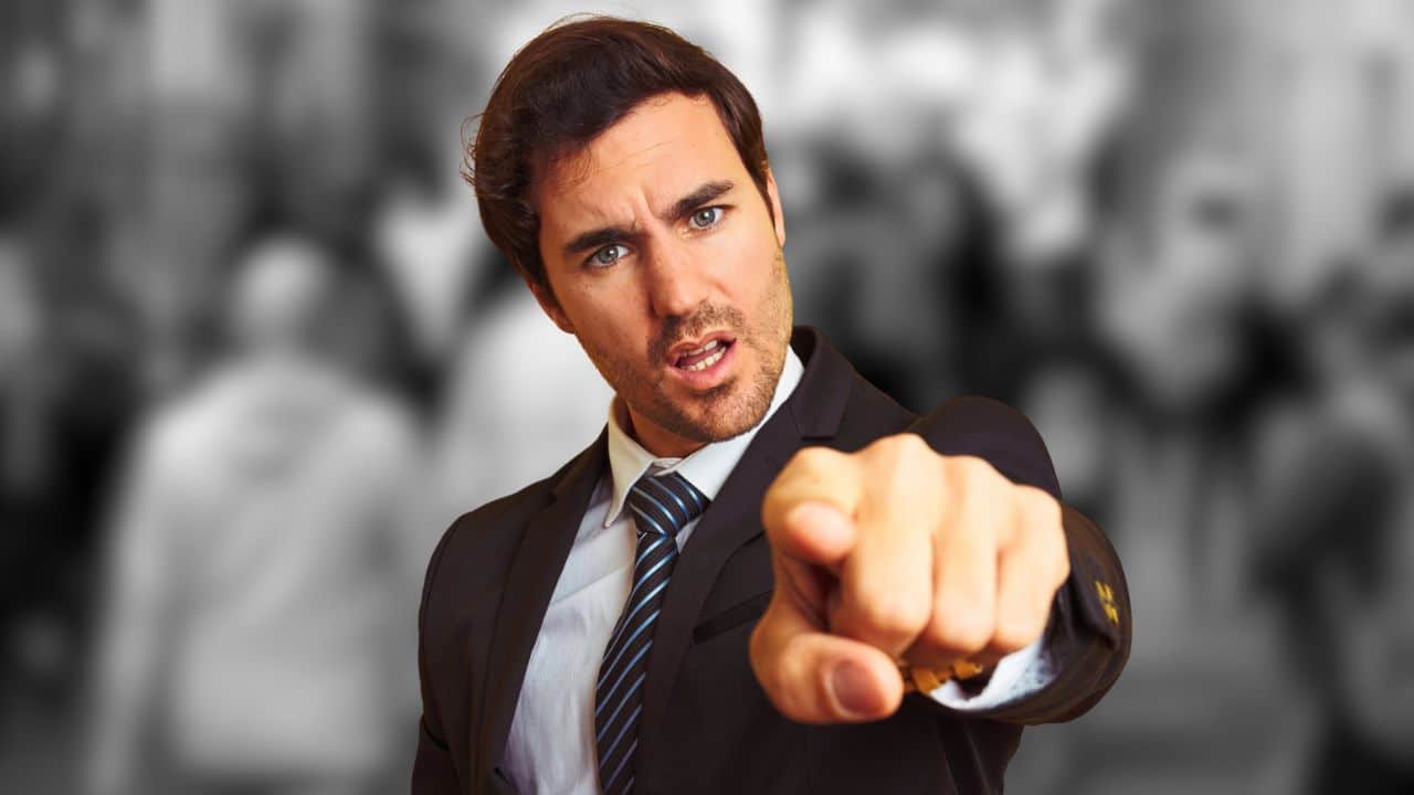 man in suit pointing blaming