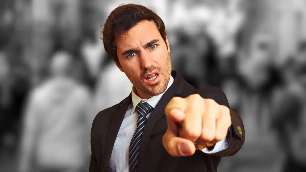 man in suit pointing blaming