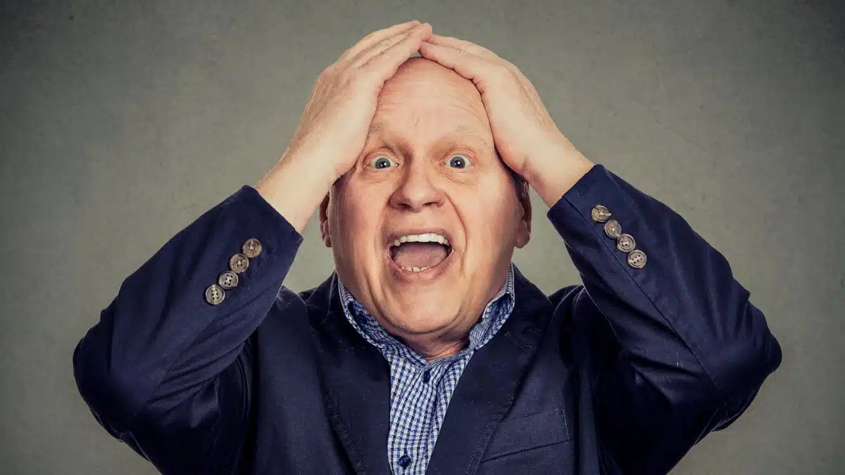 man putting hands on head