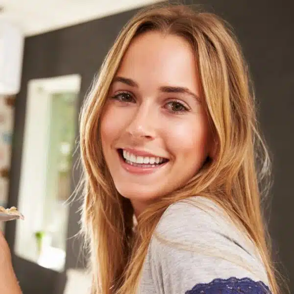 woman smiling eating food