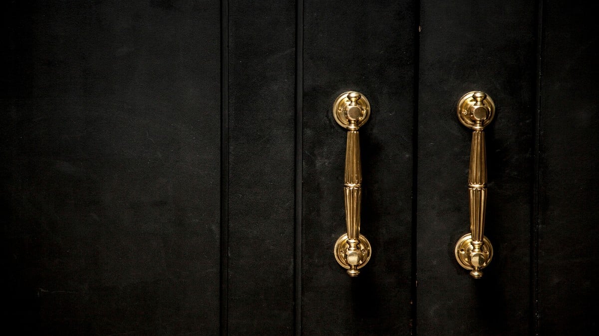 Home Features Now Priced Out of Reach Golden knob on a black wooden door