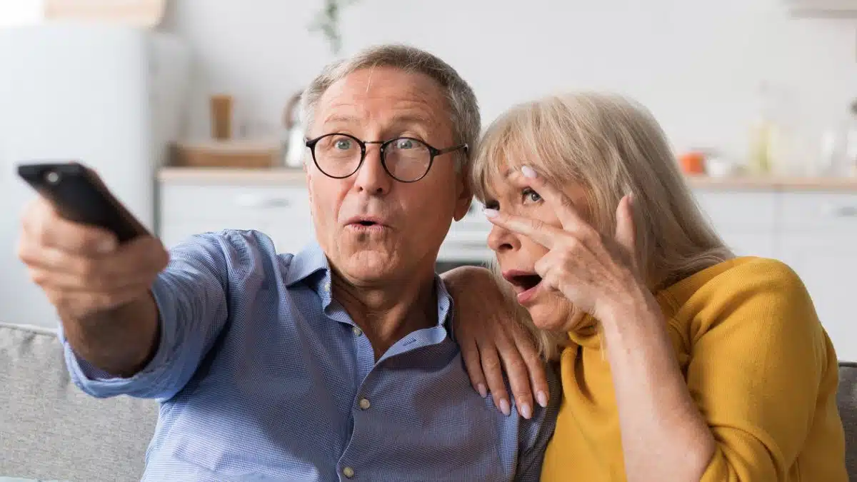 15 Clever Ways the Middle Class Use to Stretch Their Dollars elder couple covering eyes watching tv