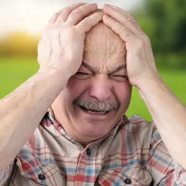 senior man crying in the park