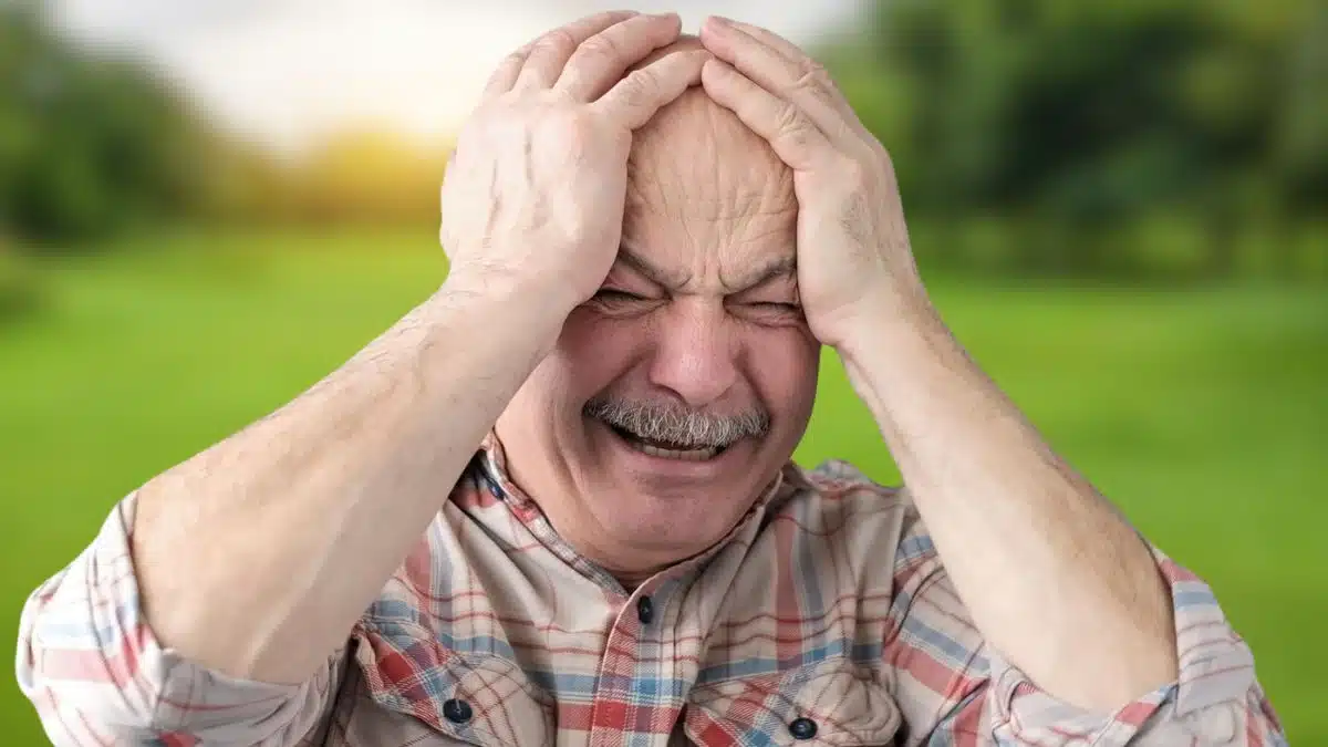 senior man crying in the park