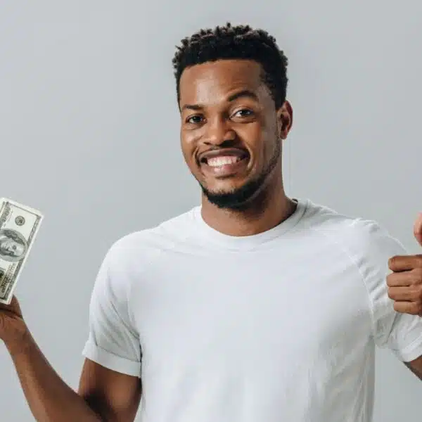 man holding cash and happy
