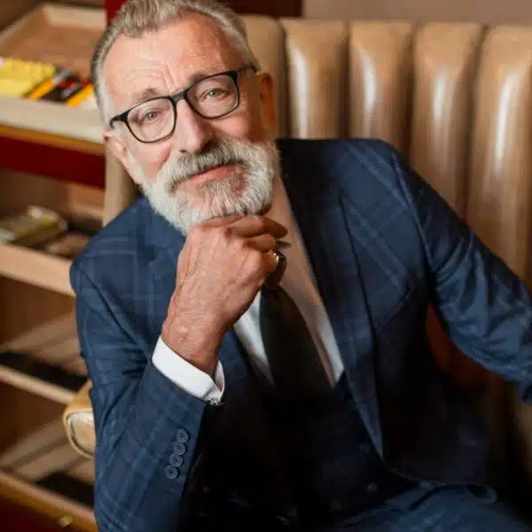 rich senior man with glasses