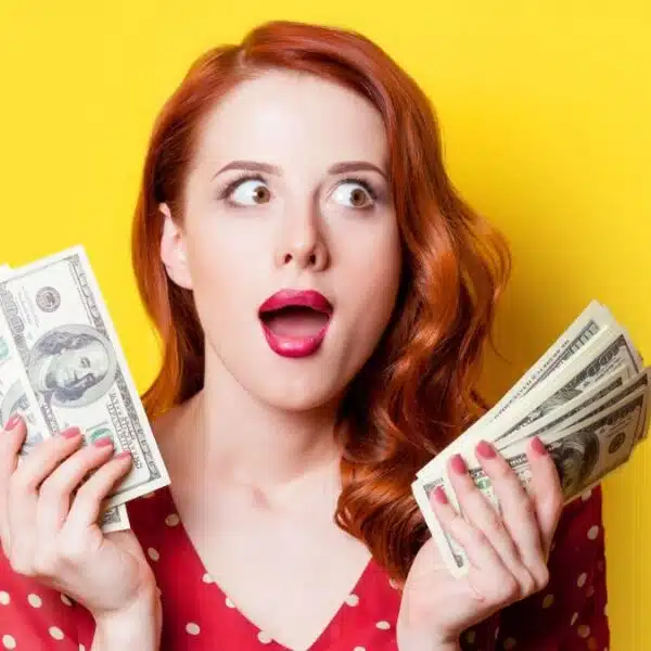 woman holding up cash