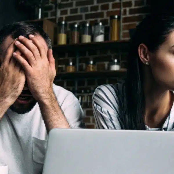 couple stressed worried about money laptop
