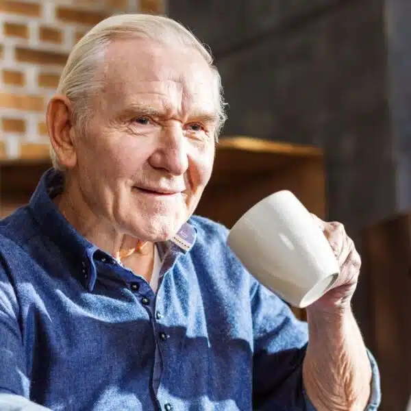 senior man coffee laptop