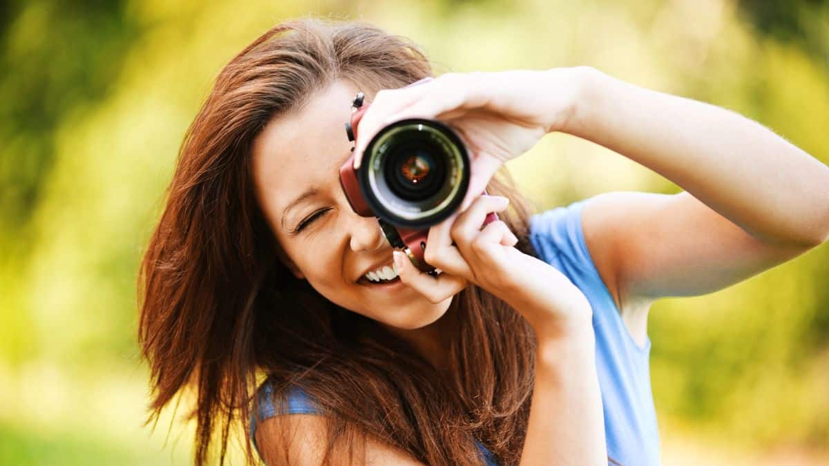 How Millionaires Multiply Their Earnings woman with a camera