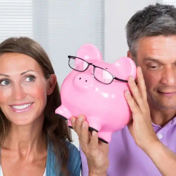 couple listening to a piggy bank