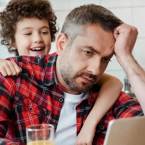 dad busy and tired on laptop