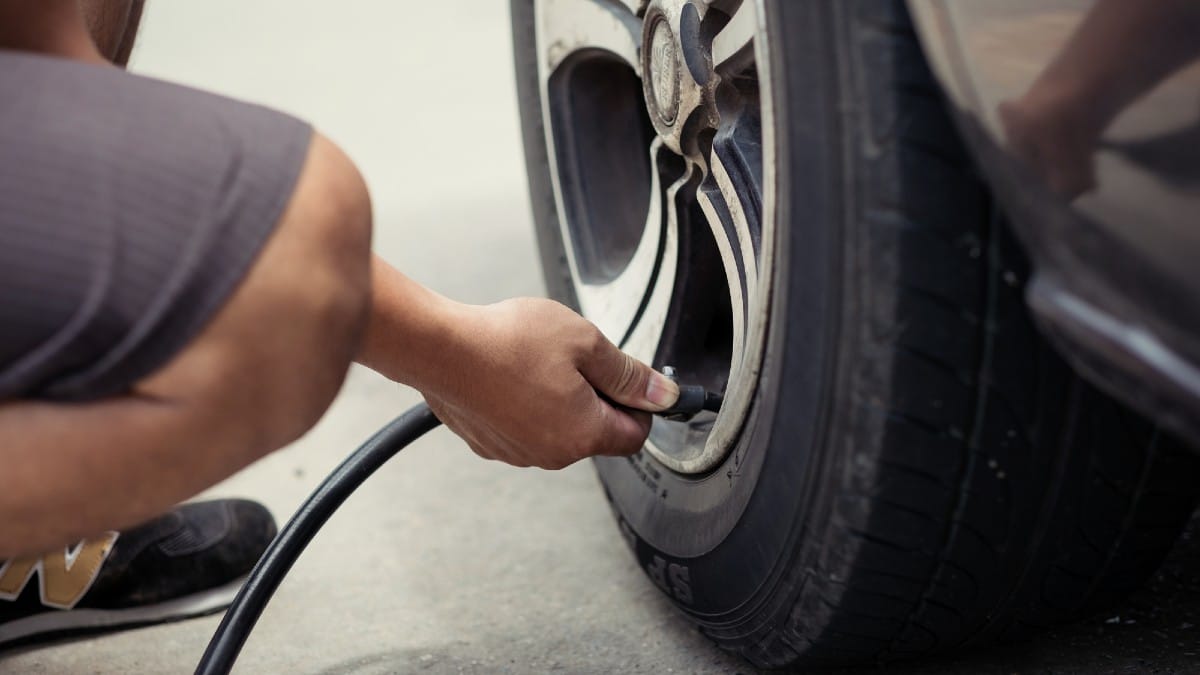 15 Used Bargains That Can Secretly Cost You More Man-driver-checking-air-pressure-and-filling-air-in-the-tires