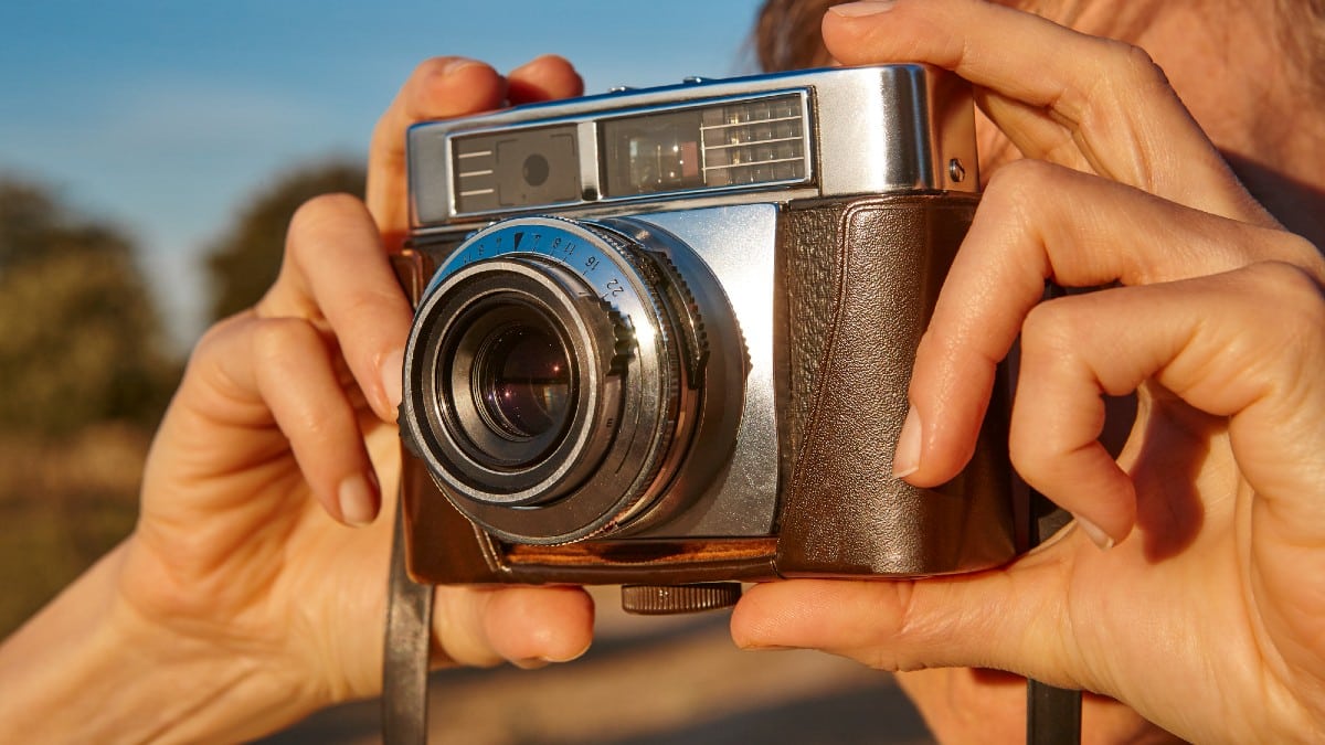 Ways Creators Can Turn Ideas Into Income Woman-taking-pictures-with-vintage-camera.-Travel