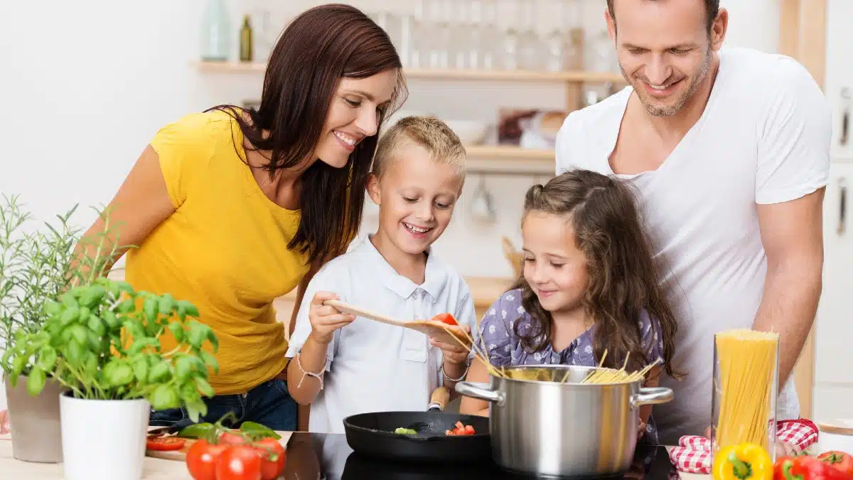 15 Clever Ways the Middle Class Use to Stretch Their Dollars Young-family-cooking-in-the-kitchen