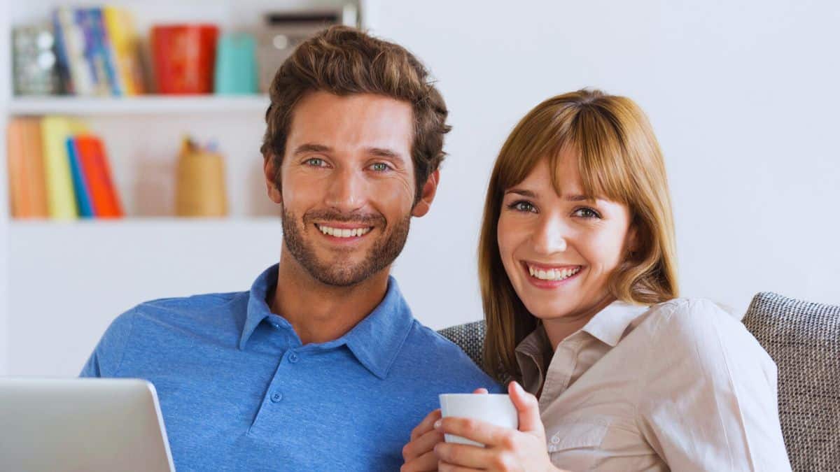 The $250K Habits Rich People Swear By couple looking at laptop