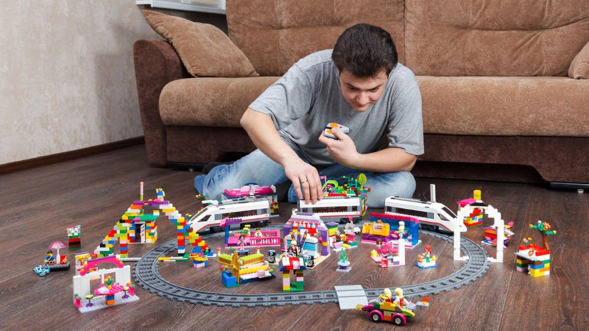 12 Childhood Favorites People Can’t Afford Anymore man playing lego