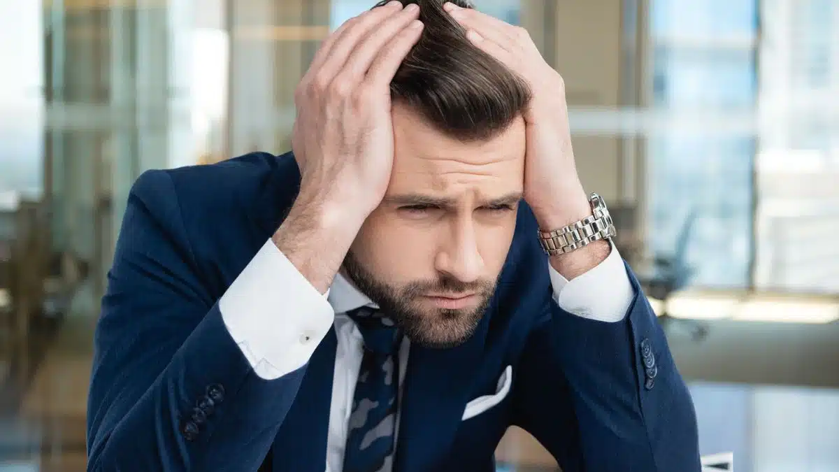 man sitting at desk with a blue suit