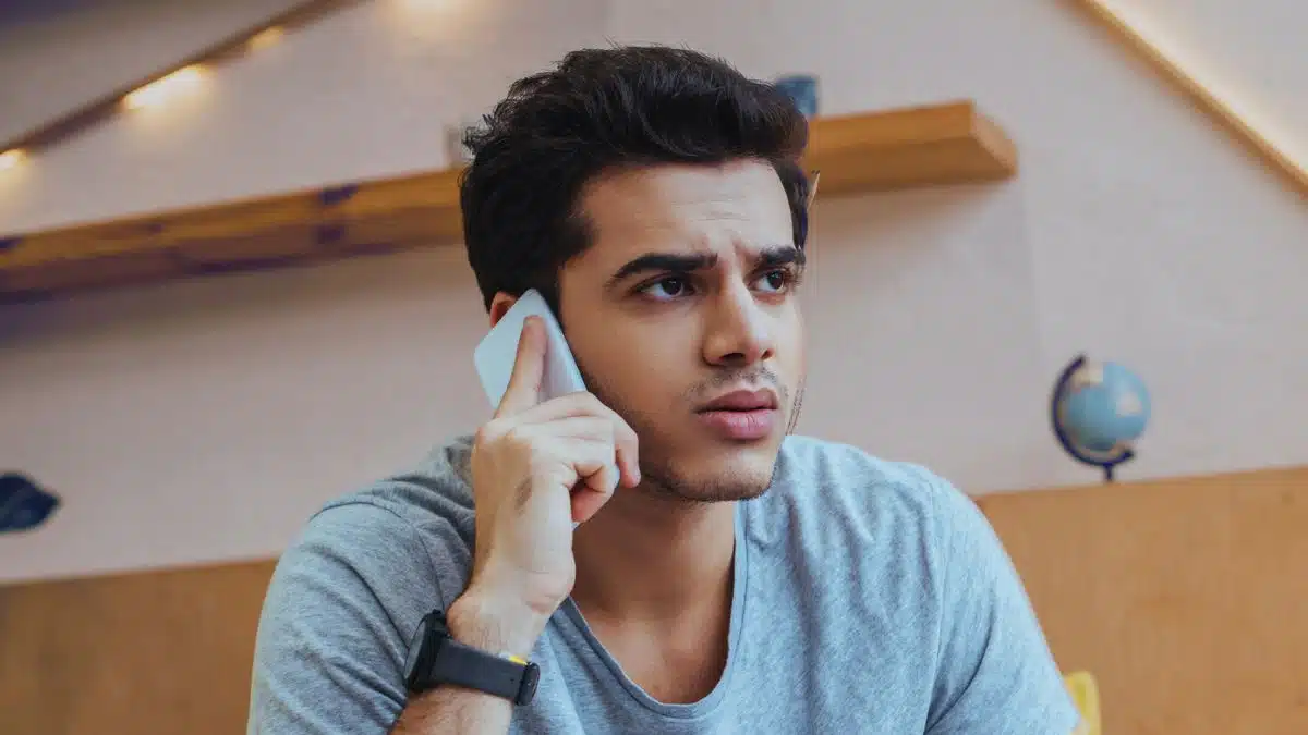 15 Clever Ways the Middle Class Use to Stretch Their Dollars man sitting worried couch on phone