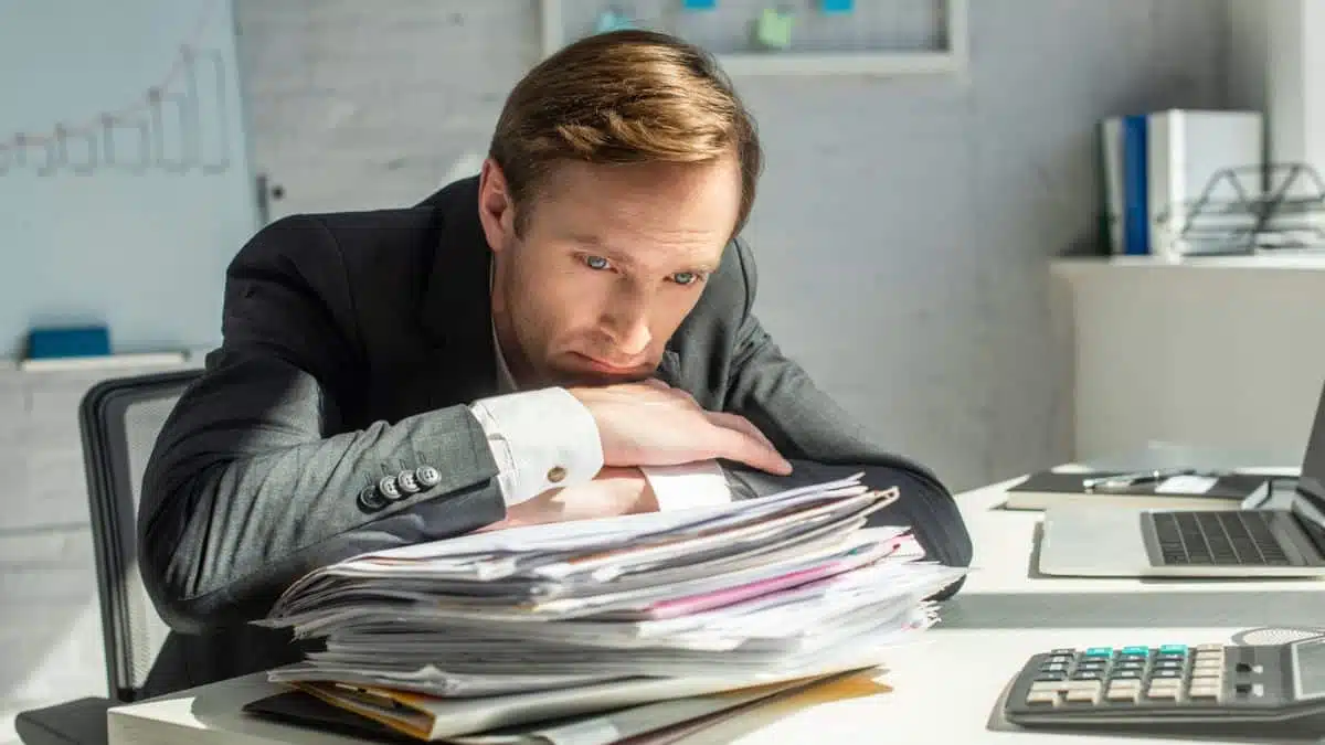 9 Career Choices That Can Cost You Later in Life man-with-a-stack-of-papers-sad
