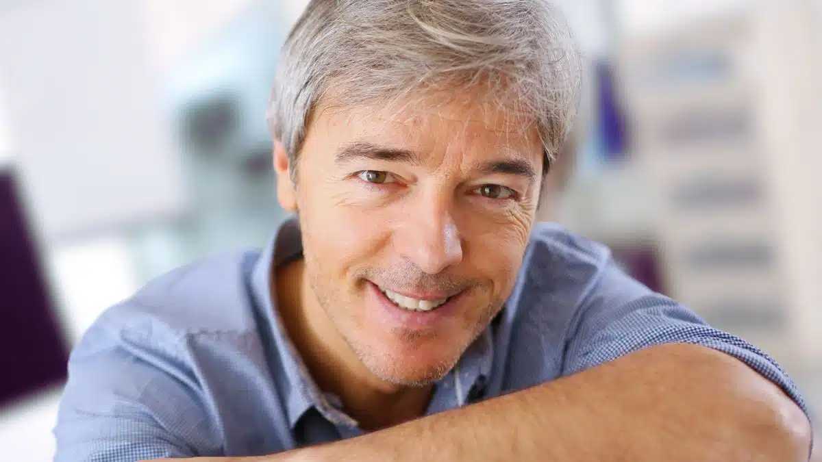 mature man smiling in office