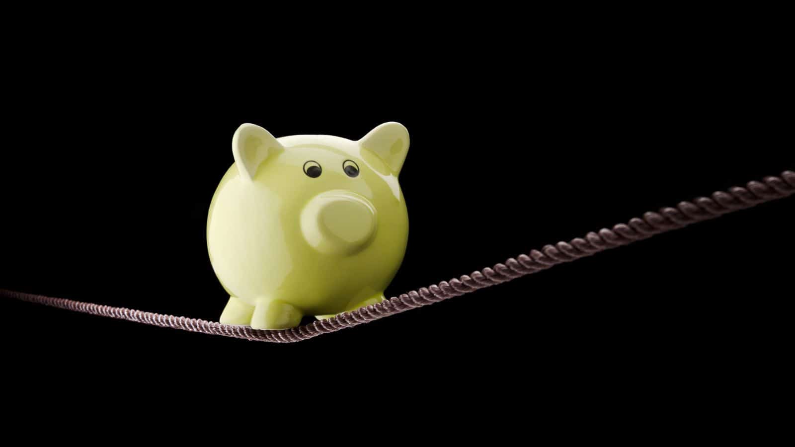 15 Ways to Know It’s Time to Quit Your Job unstable-income-piggy-bank-on-tightrope