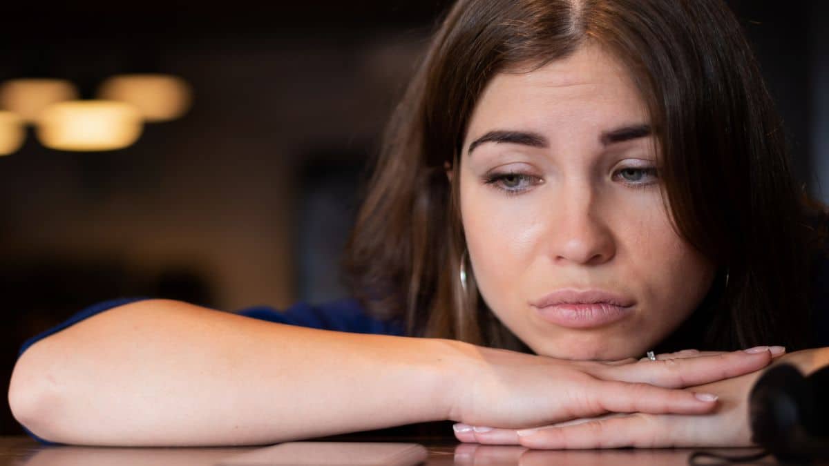 woman-sad-laying-on-a-table