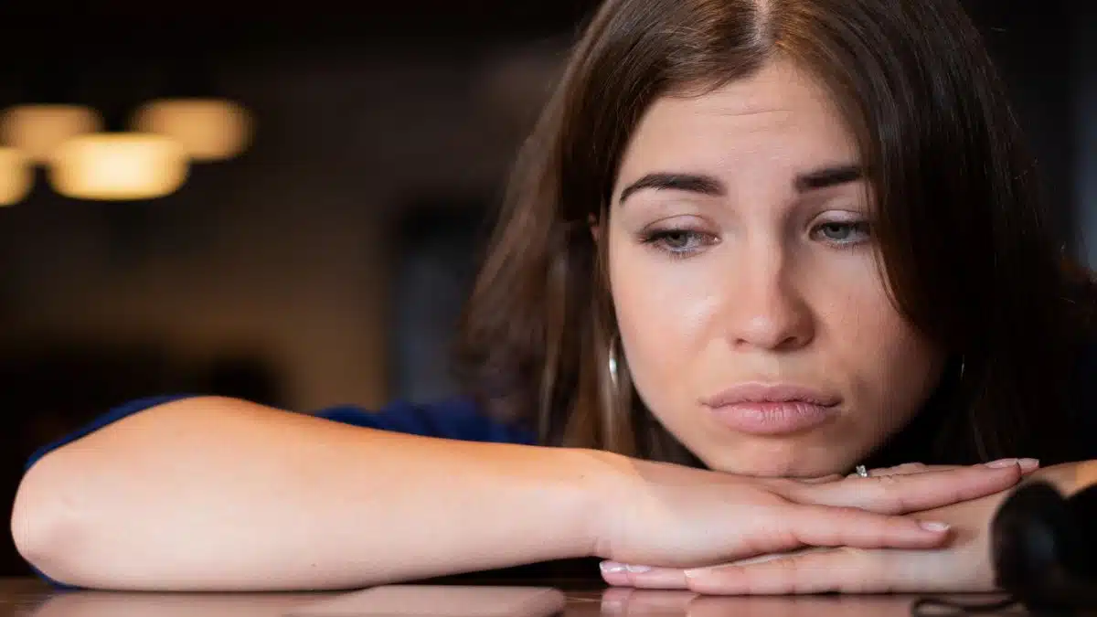 woman-sad-laying-on-a-table