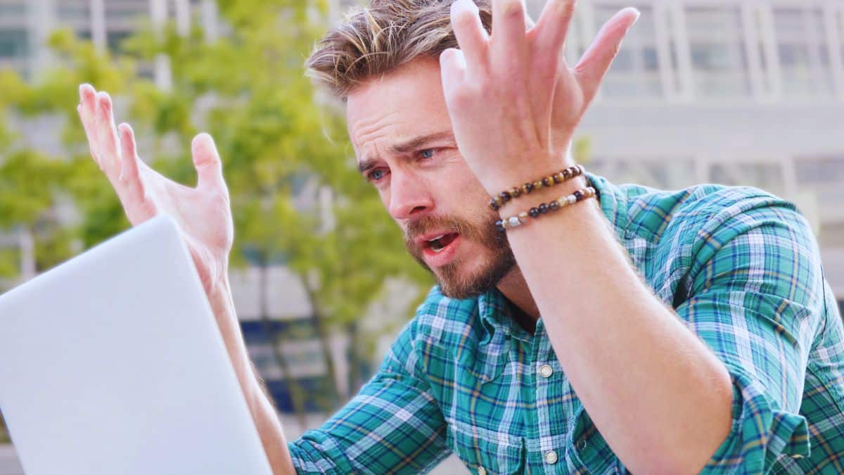 15 Unnoticed Habits That Sabotage Your Savings man laptop frustrated mad