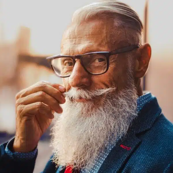 senior man with beard suit tie glasses