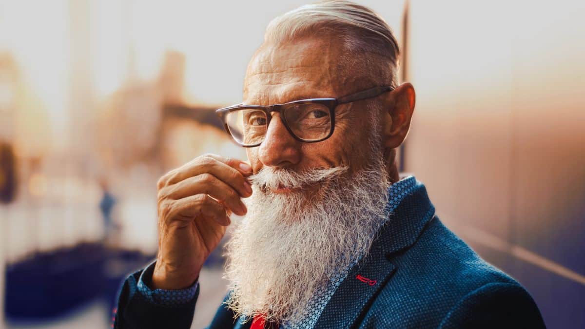 senior man with beard suit tie glasses
