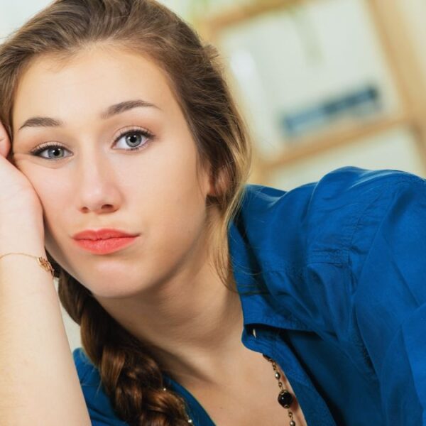 woman resting on hand sad worried guilty