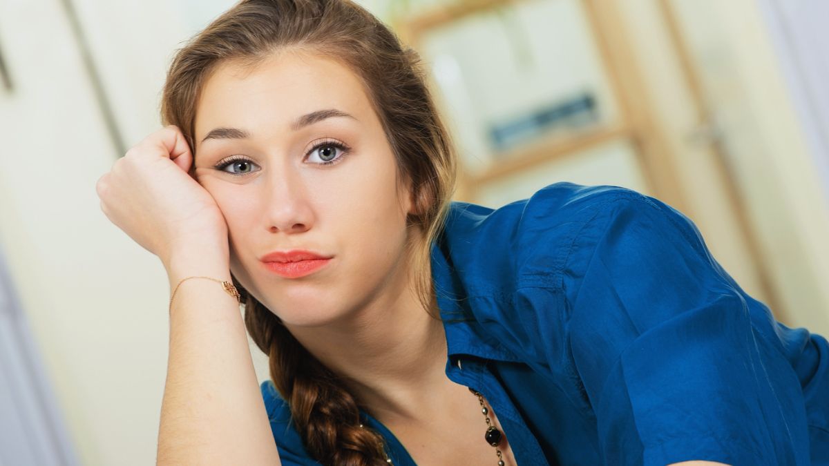 woman resting on hand sad worried guilty