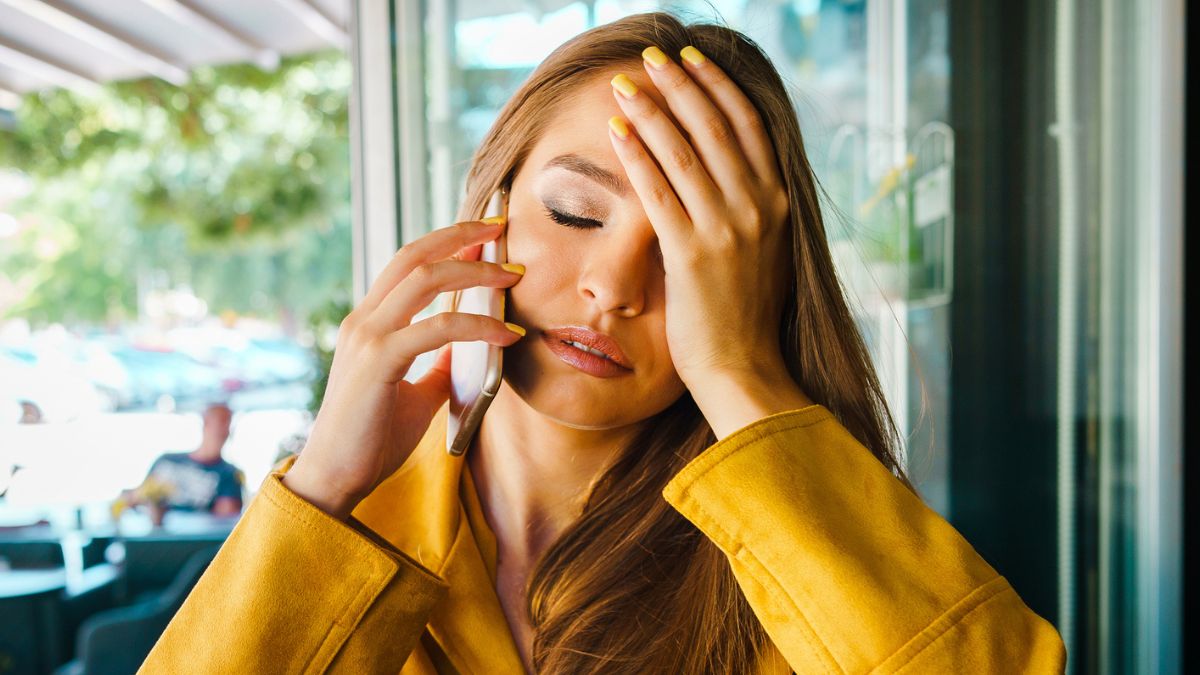 woman phone sad regret