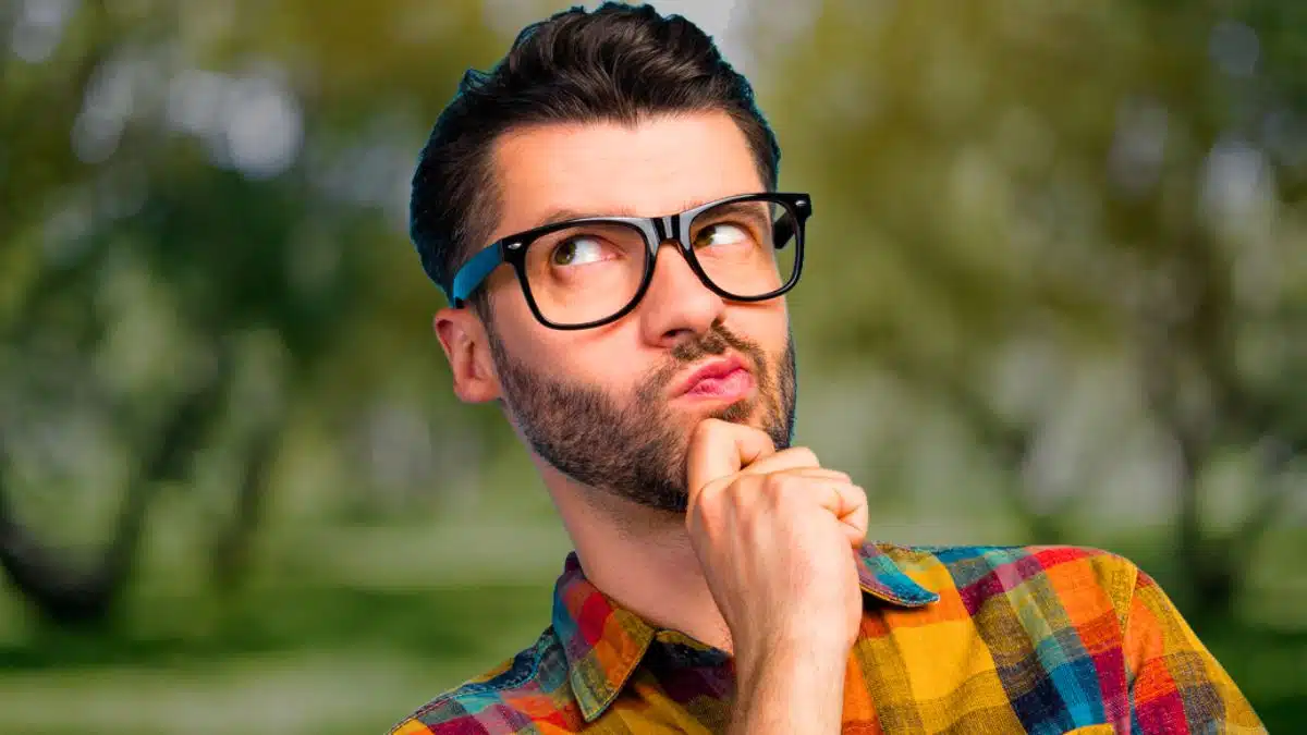 man glasses curious listening
