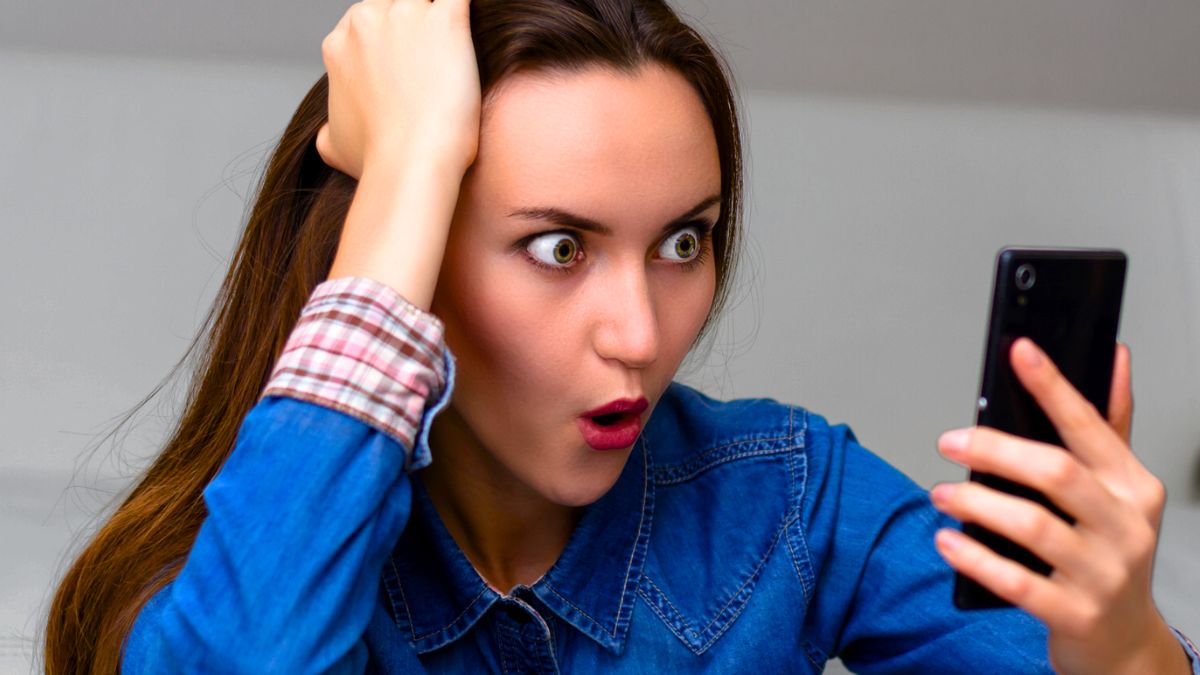 woman phone shock reading