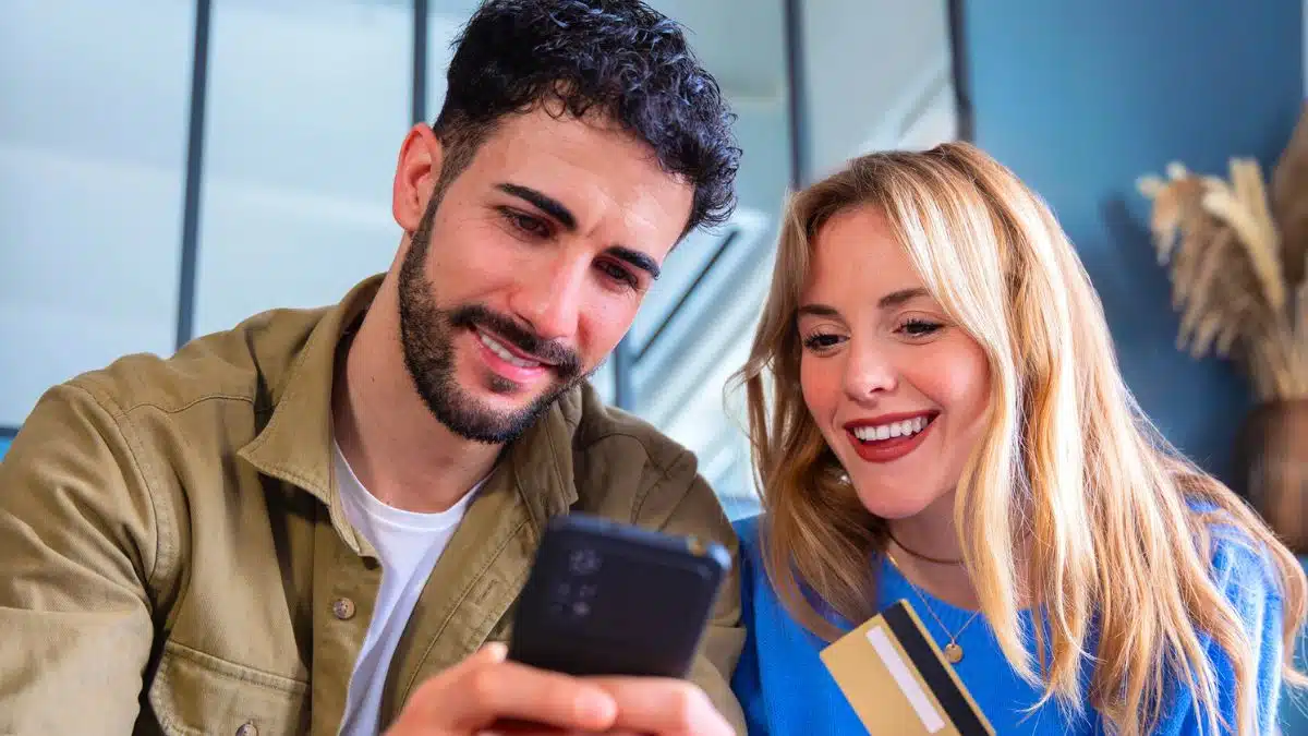 couple phone credit card happy