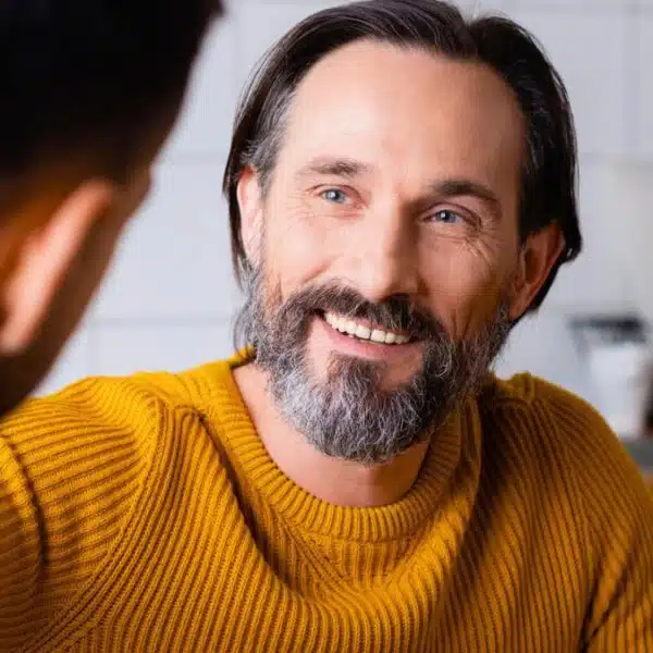 man beard coffee talking in kitchen