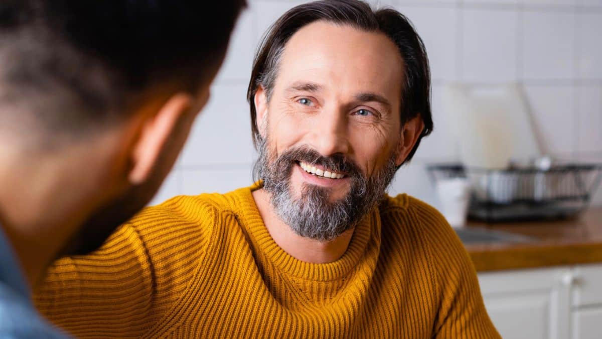 man beard coffee talking in kitchen